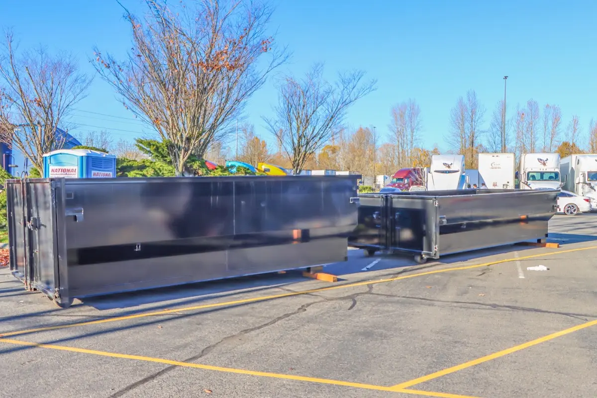 Professional dumpster rental service with roll-off container on residential driveway in Valley Stream